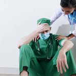 Nurse reassuring stressed surgeon